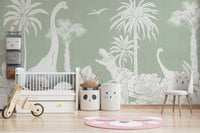 Monochrome Dino Green wallpaper mural with white dinosaurs and palms in a nursery with a white crib and balance bike