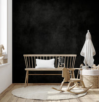 Dirty Paper - Cave wallpaper mural of a textured black wall in a nursery with a wood bench and rocking horse