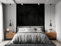 Dirty Paper - Cave wallpaper mural of a black textured wall behind a grey bed flanked by wood nightstands