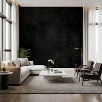 Dirty Paper - Cave wallpaper mural of a black plaster wall in a living room with a cream sectional and leather chairs