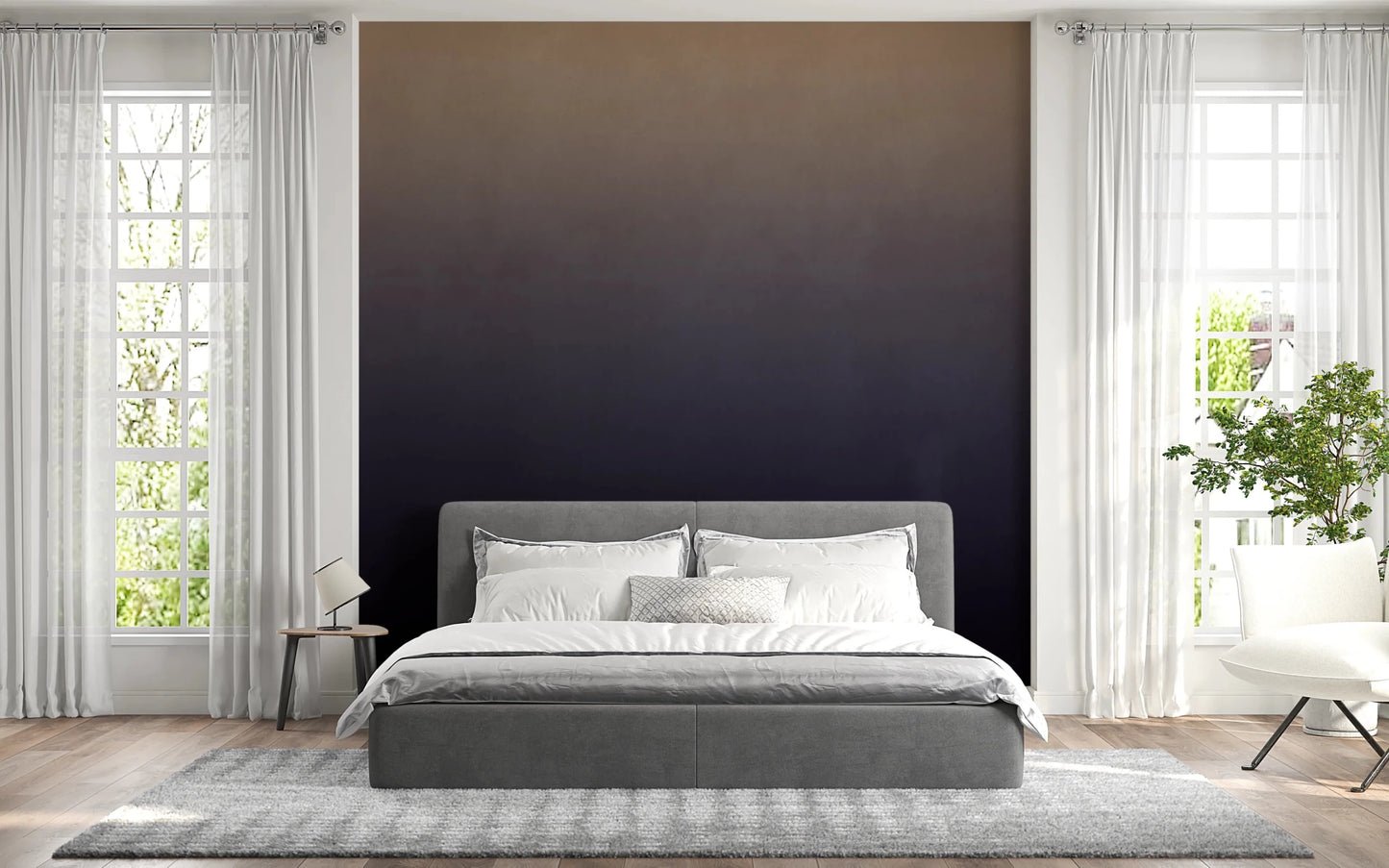 Dirty Paper - Ombre Dusk wallpaper mural of a tan-to-navy gradient behind a grey bed between bright windows