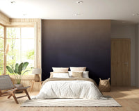 Dirty Paper - Ombre Dusk wallpaper mural of a gold-to-navy gradient behind a white bed in a cabin bedroom