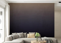 Dirty Paper - Ombre Dusk wallpaper mural fading tan to navy behind a cream sectional in a living room