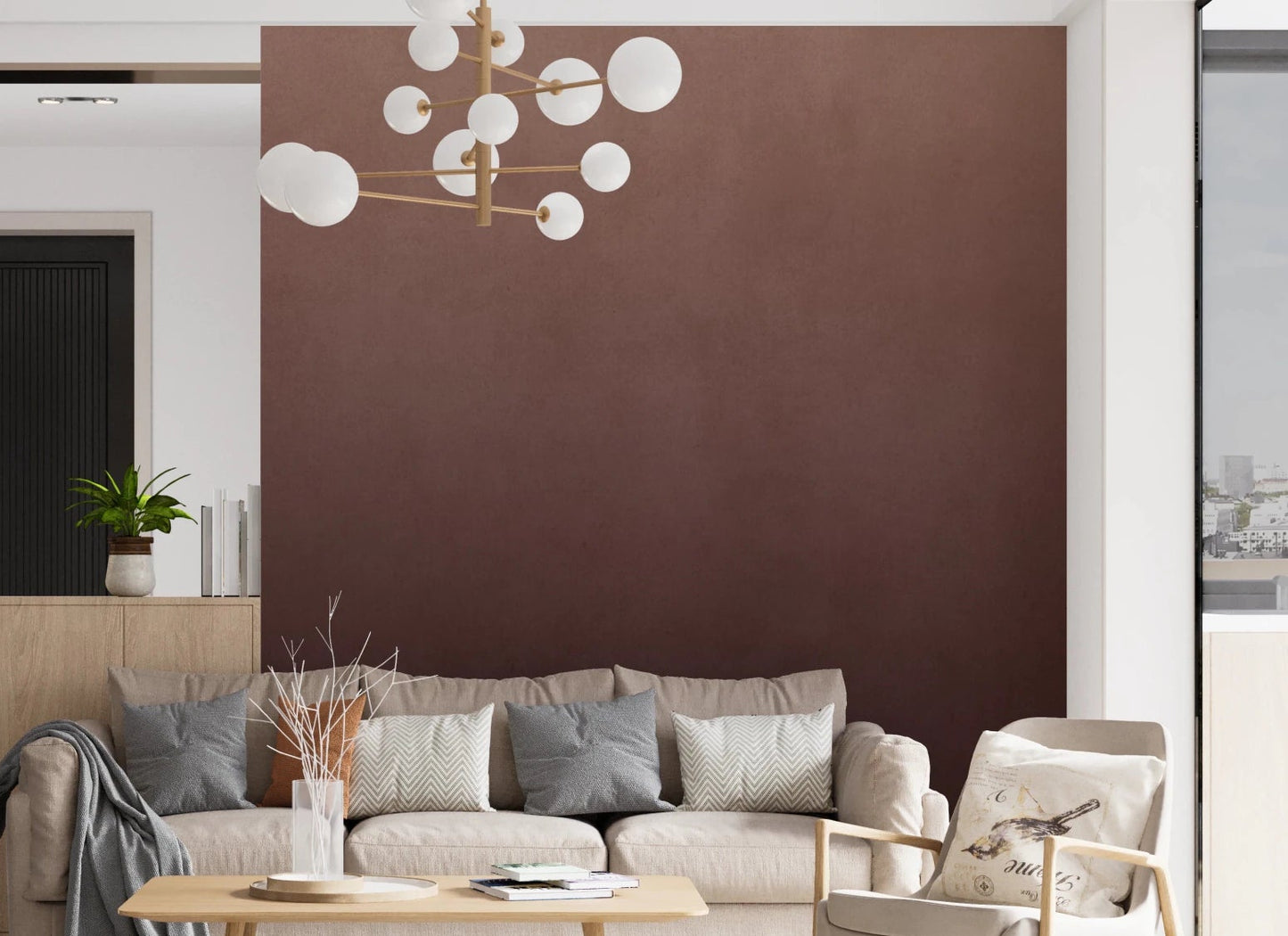 Dirty Paper Ombre Peach wall mural in peach-to-maroon gradient behind a beige sofa and gold bubble chandelier