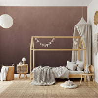 Dirty Paper Ombre Peach wall mural in a kids room with wooden house bed, canopy and knitted throw on a jute rug