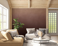 Dirty Paper Ombre Peach wall mural in a wood-beam living room with yellow and grey curved sofas and fiddle-leaf plant