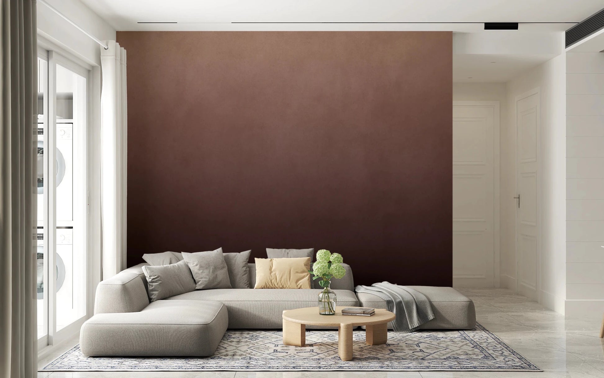 Dirty Paper Ombre Peach wall mural fading to brown behind a grey sectional with yellow cushion in a bright living room