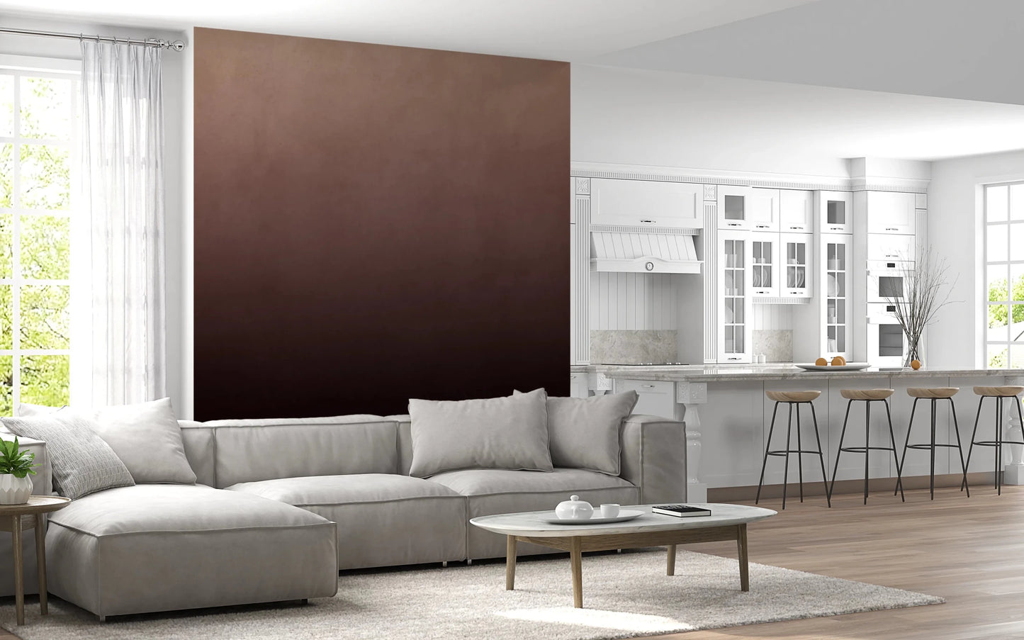 Dirty Paper Ombre Peach wall mural beside a white kitchen with bar stools and a grey sectional in the living room