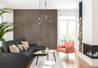 Dirty Paper Taupe wall mural behind a charcoal sofa and coral armchair with firewood stack and fireplace