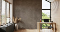 Dirty Paper Taupe wall mural in a home office with light wood desk, chair and pampas grass by a city-view window
