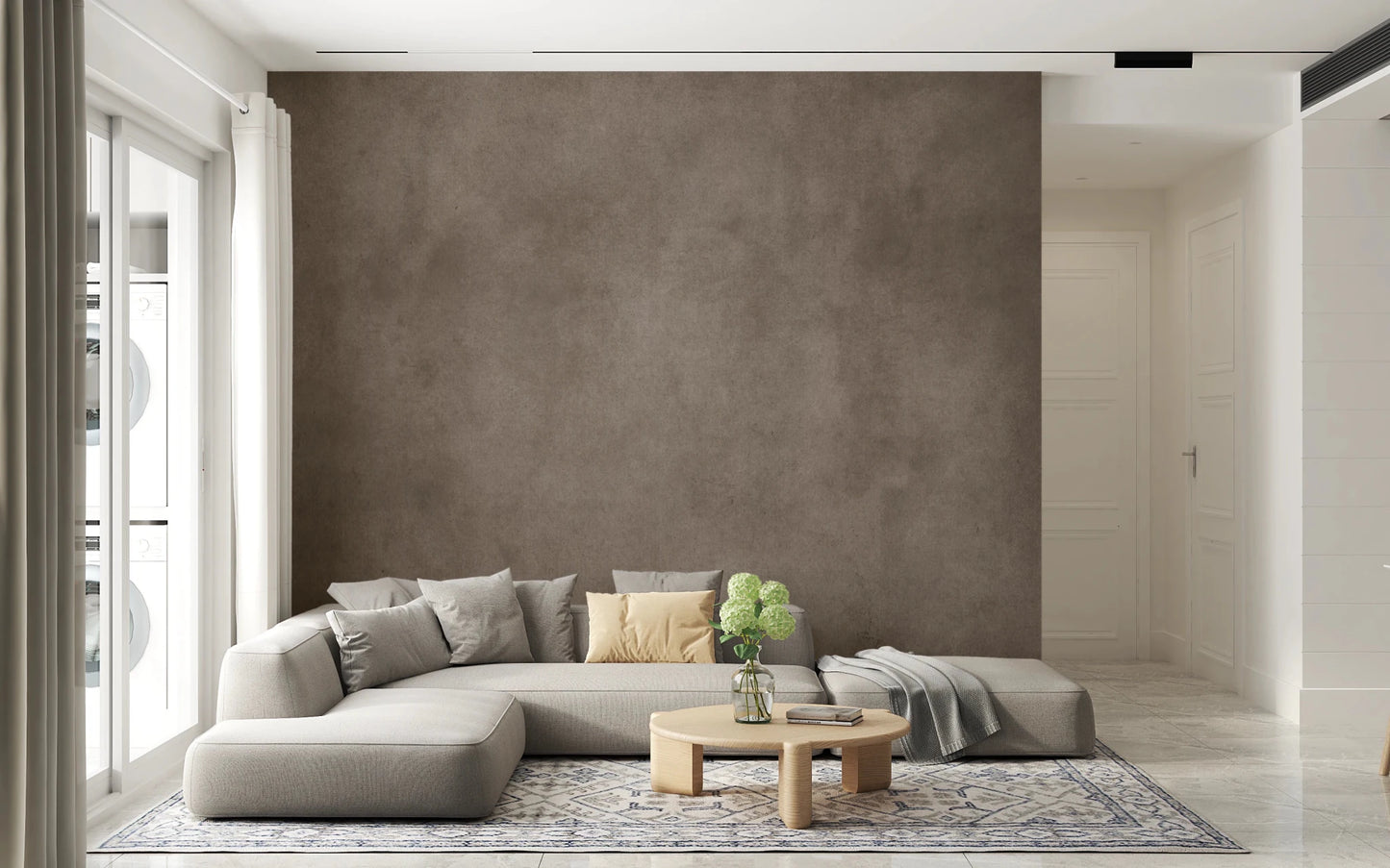 Dirty Paper Taupe wall mural as a full brown feature wall behind a beige sectional in a bright living room