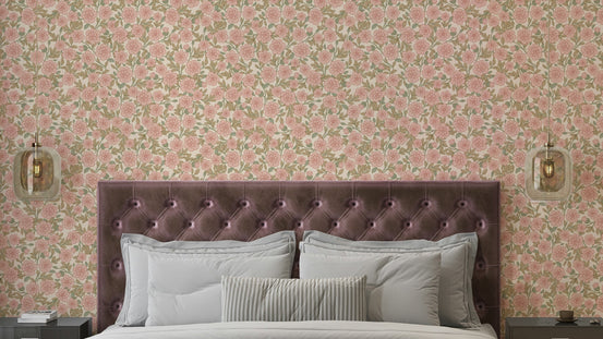 Juno Welcoming Walls Ditsy Peach Floral wallpaper in a bedroom behind a tufted mauve velvet headboard with white pillows