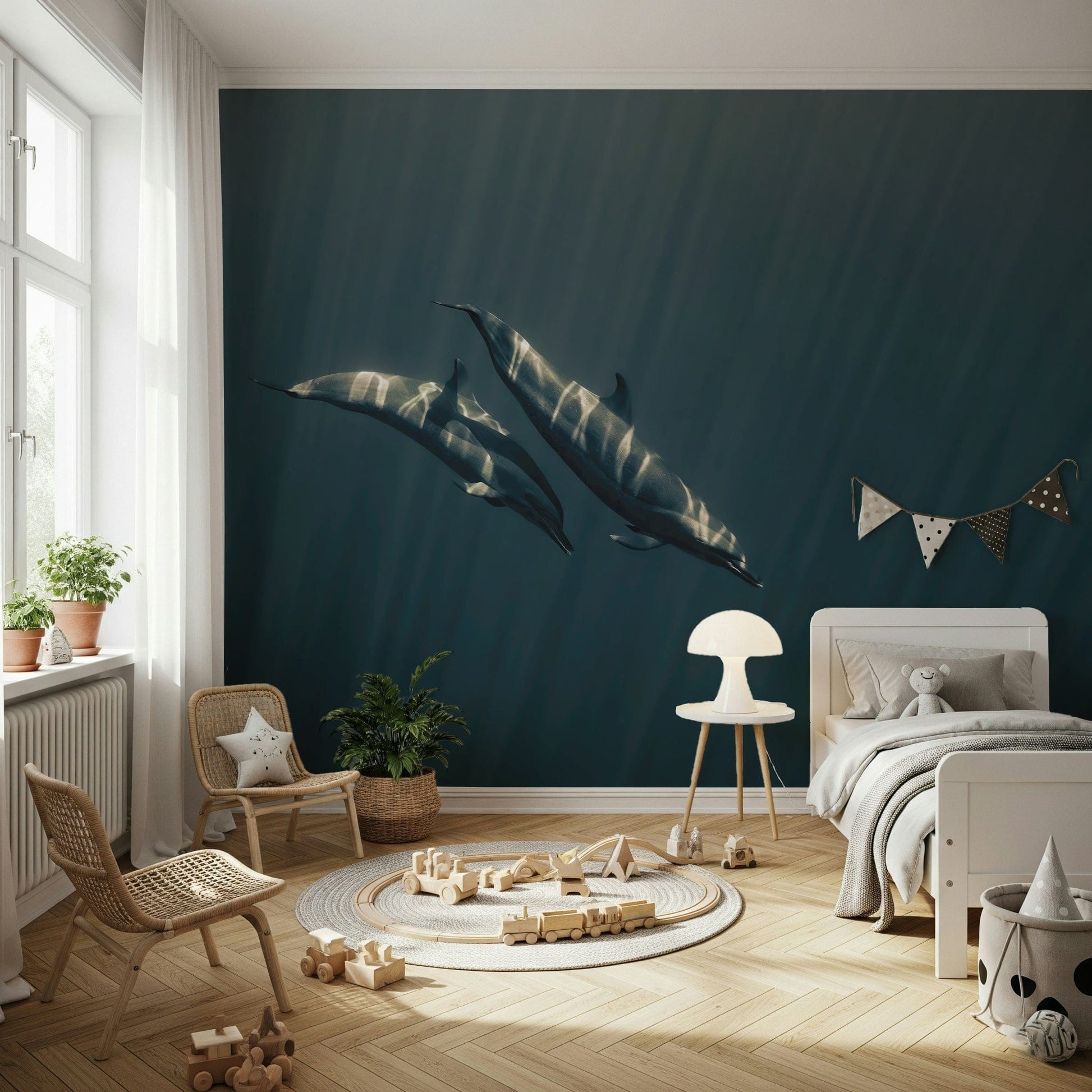 Deep Blue Journey wallpaper mural of two dolphins in sunlit blue water behind a white bed and wooden train rug in a child's bedroom