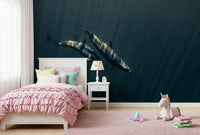 Deep Blue Journey wallpaper mural of two dolphins in blue water above a pink ruffled bed and unicorn plush in a girl's bedroom