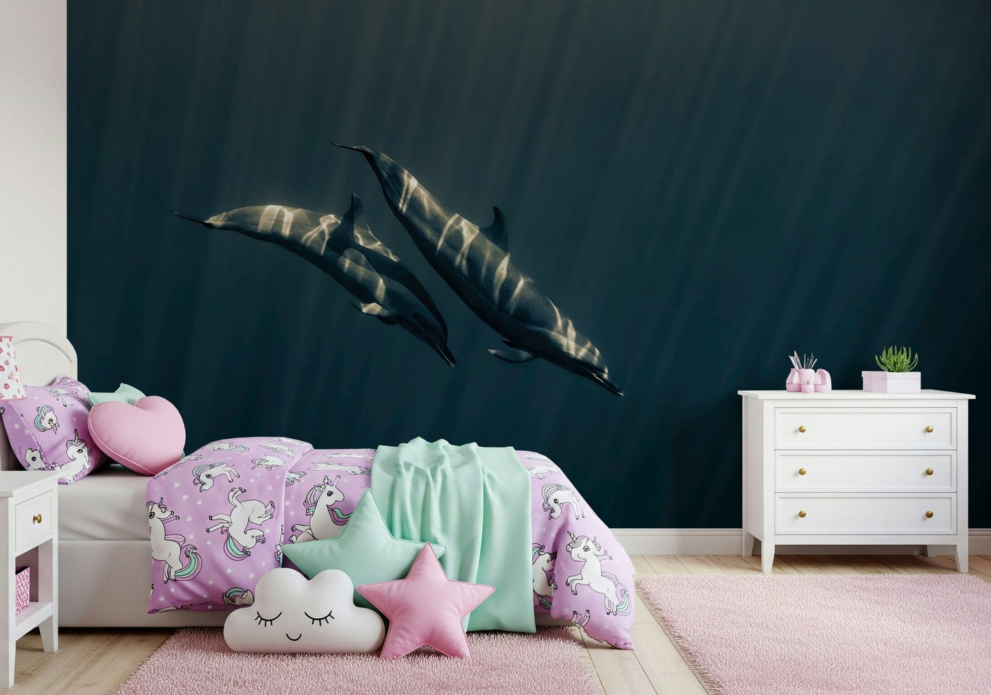Deep Blue Journey wallpaper mural of two dolphins swimming in dark blue water above a unicorn-themed bed in a girl's bedroom