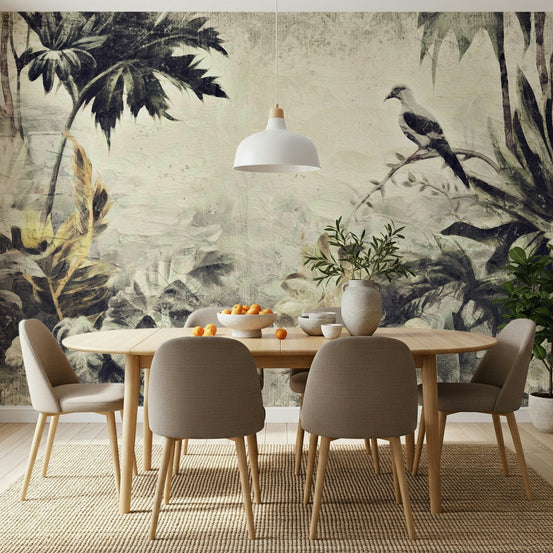 Painted Dove Haven wallpaper mural of a vintage jungle with a perched dove behind a light wood dining table and tan chairs