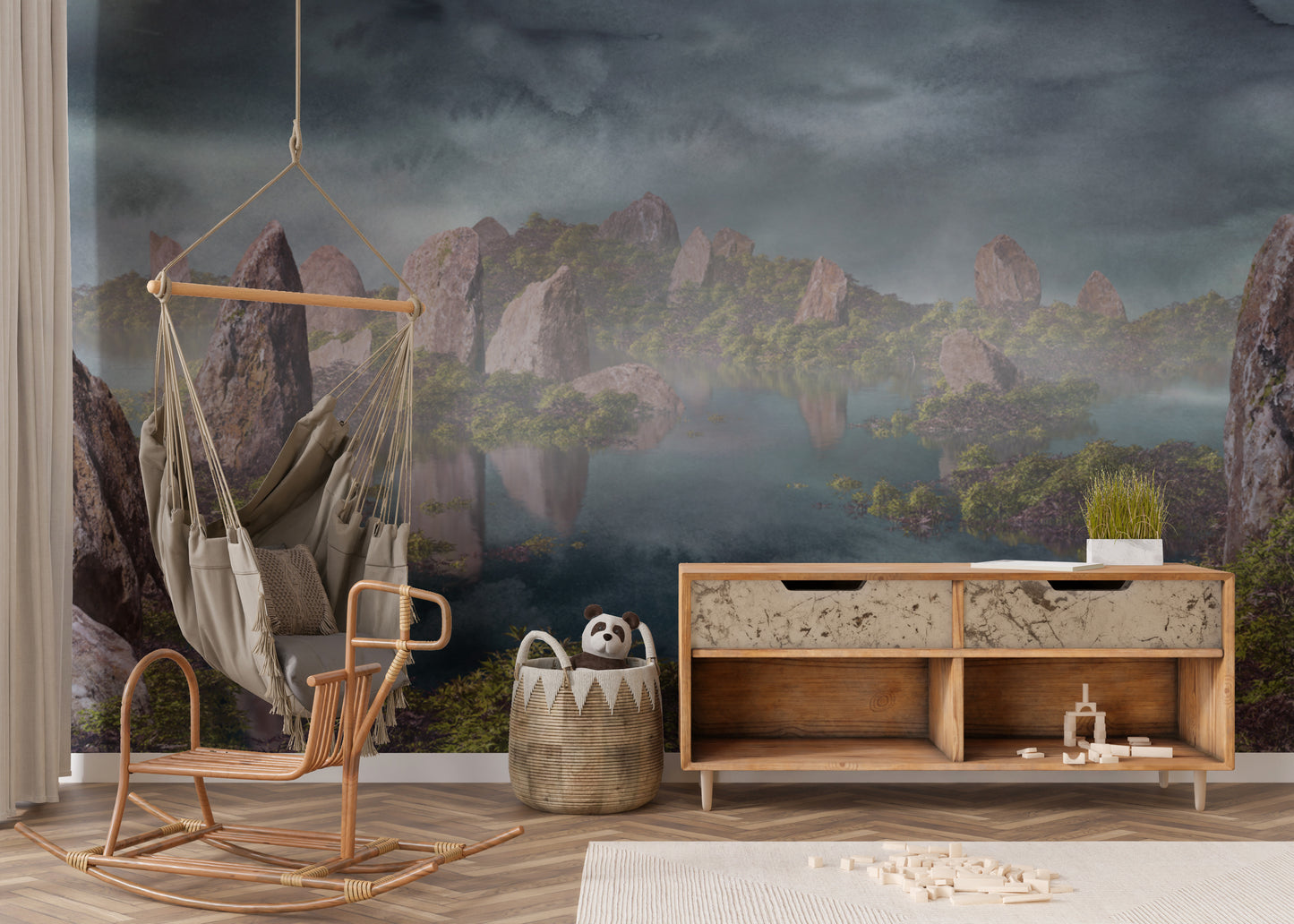 Dramatic Chinese Landscape Blue wallpaper mural of misty peaks over water in a nursery with a rattan swing chair and toys