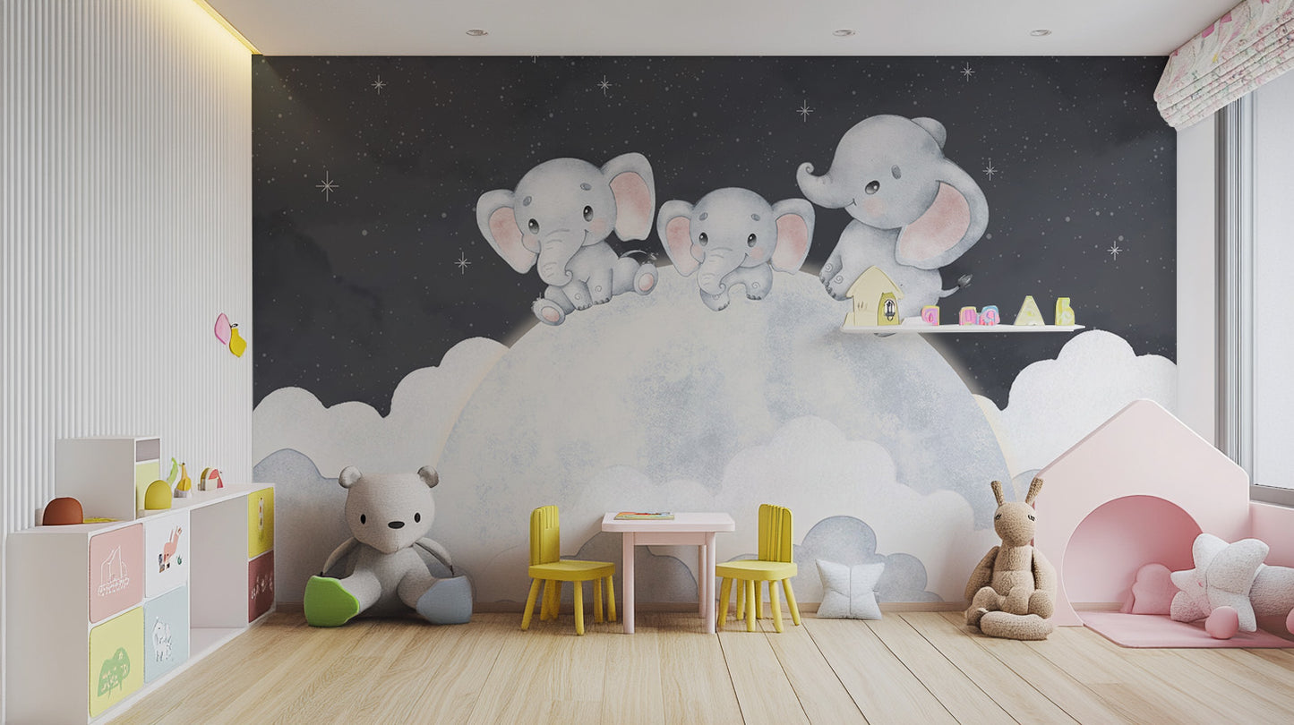 Dreamy baby elephant wallpaper mural with grey elephants on a starry cloud in a kids playroom with yellow chairs