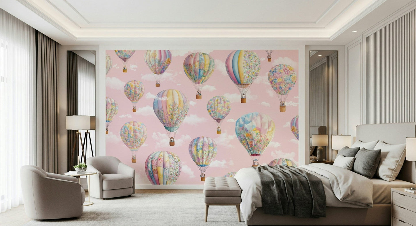 Dreamy Balloon Voyage wallpaper mural of pastel balloons on pink sky in a bedroom behind a bed with grey throw