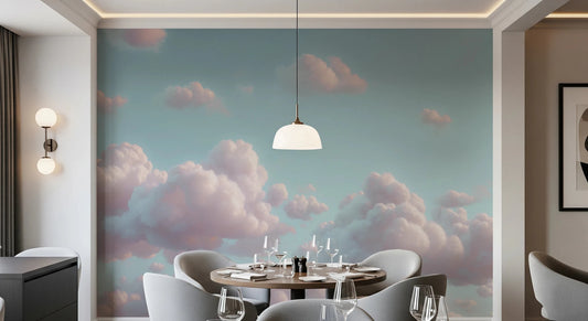 Dreamy Skies mural of pastel pink clouds behind a round dining table with grey chairs and a white pendant lamp