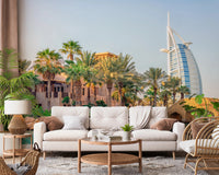 Dubai Oasis wallpaper mural of a palm resort and Burj Al Arab behind a white sofa and rattan chair in a lounge