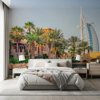 Dubai Oasis wallpaper mural of palms and the Burj Al Arab behind an upholstered bed in a bedroom