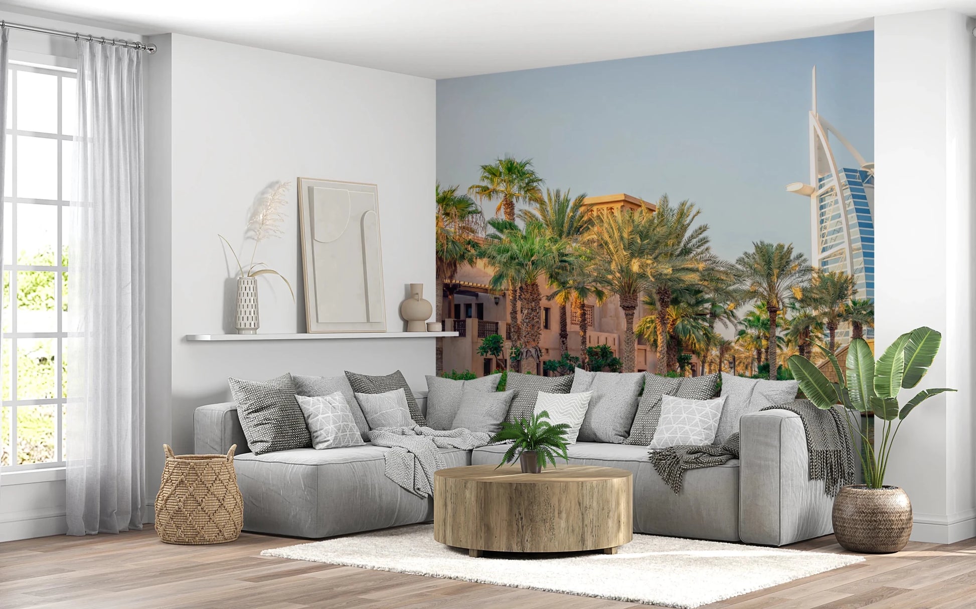 Dubai Oasis wallpaper mural of the Burj Al Arab and palms behind a grey sectional sofa in a living room