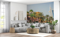 Dubai Oasis wallpaper mural of the Burj Al Arab and palms behind a grey sectional sofa in a living room