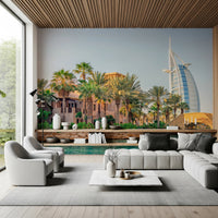 Dubai Oasis wallpaper mural of the Dubai resort and Burj Al Arab behind a white sectional and grey swivel chairs