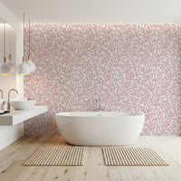 Dusty Rose Vines wallpaper with pink foliage on cream behind a freestanding tub and twin sinks in a bathroom