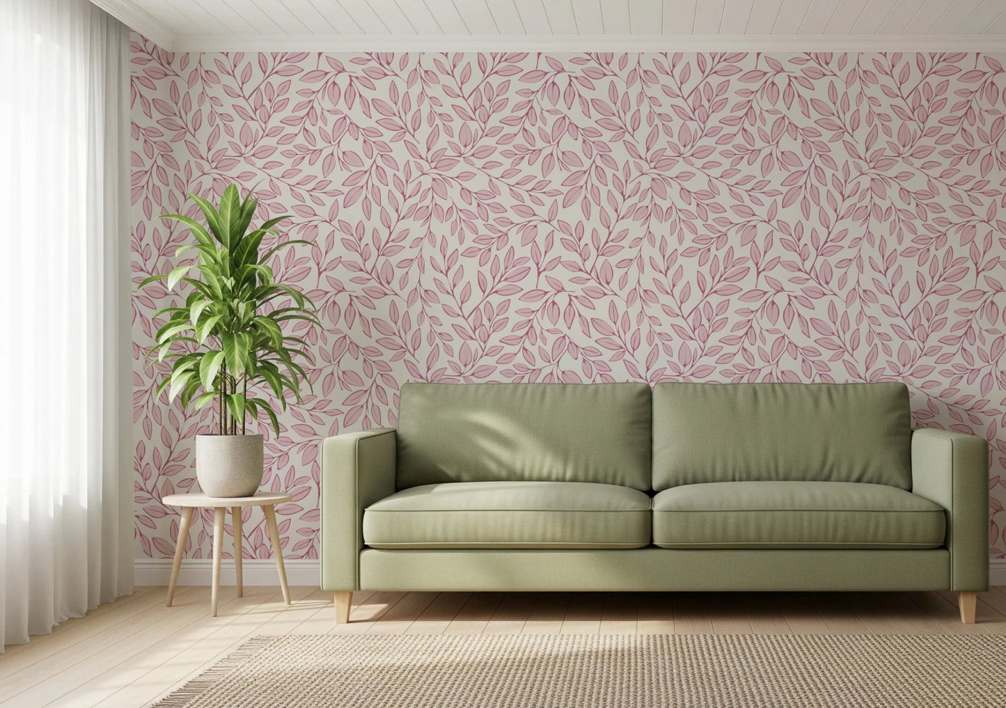 Dusty Rose Vines wallpaper of pink foliage on cream behind a sage green sofa and potted plant in a living room