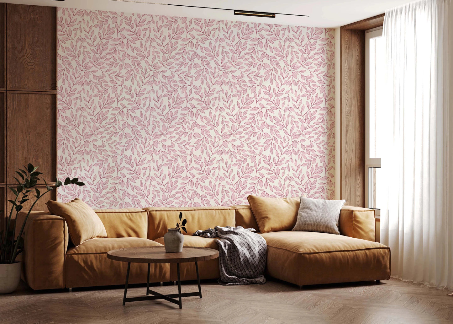Dusty Rose Vines wallpaper with pink leaves behind a mustard sectional sofa and round coffee table