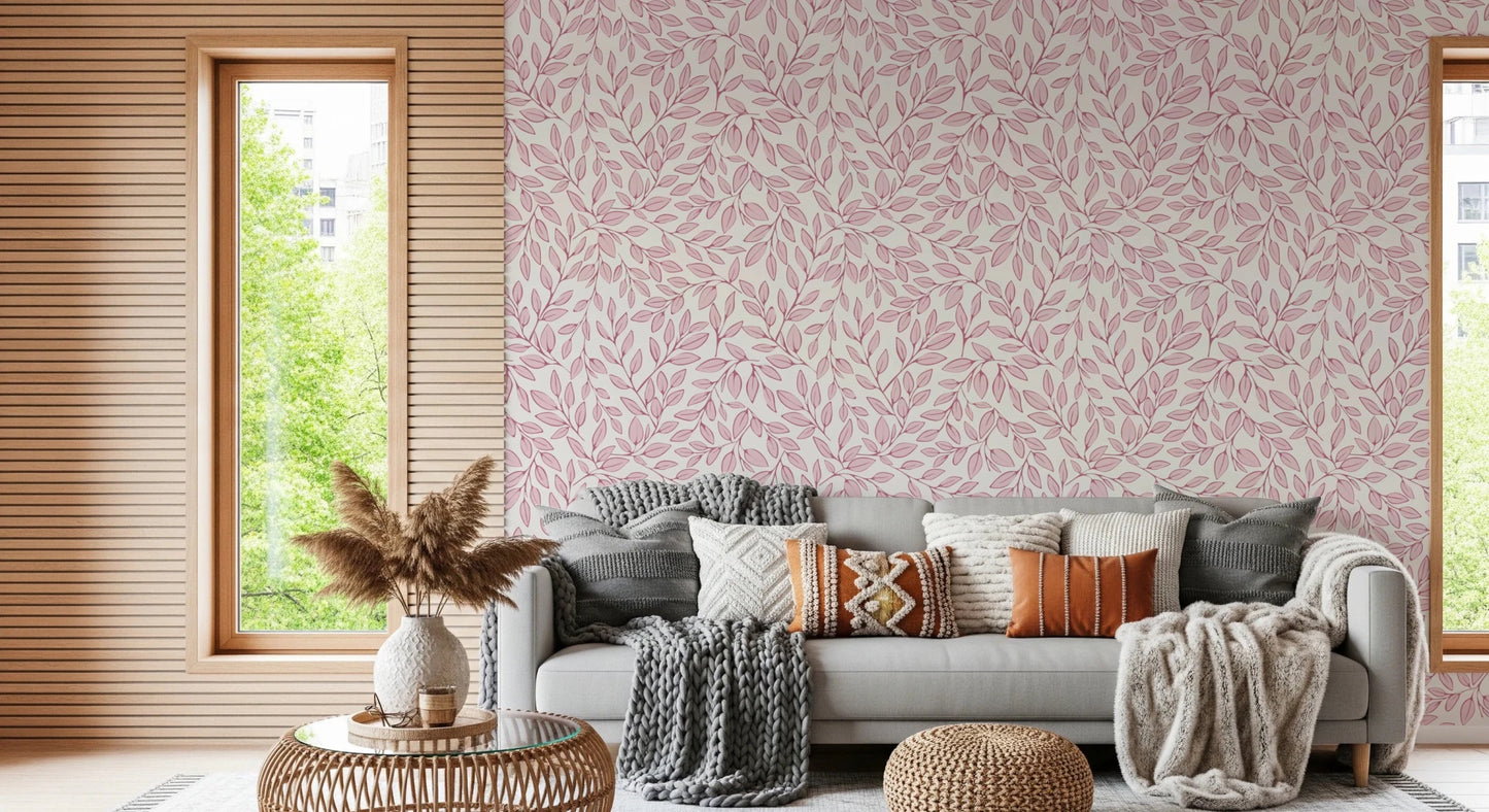 Dusty Rose Vines wallpaper with pink leaves behind a grey sofa with knit throws beside a slatted wood window