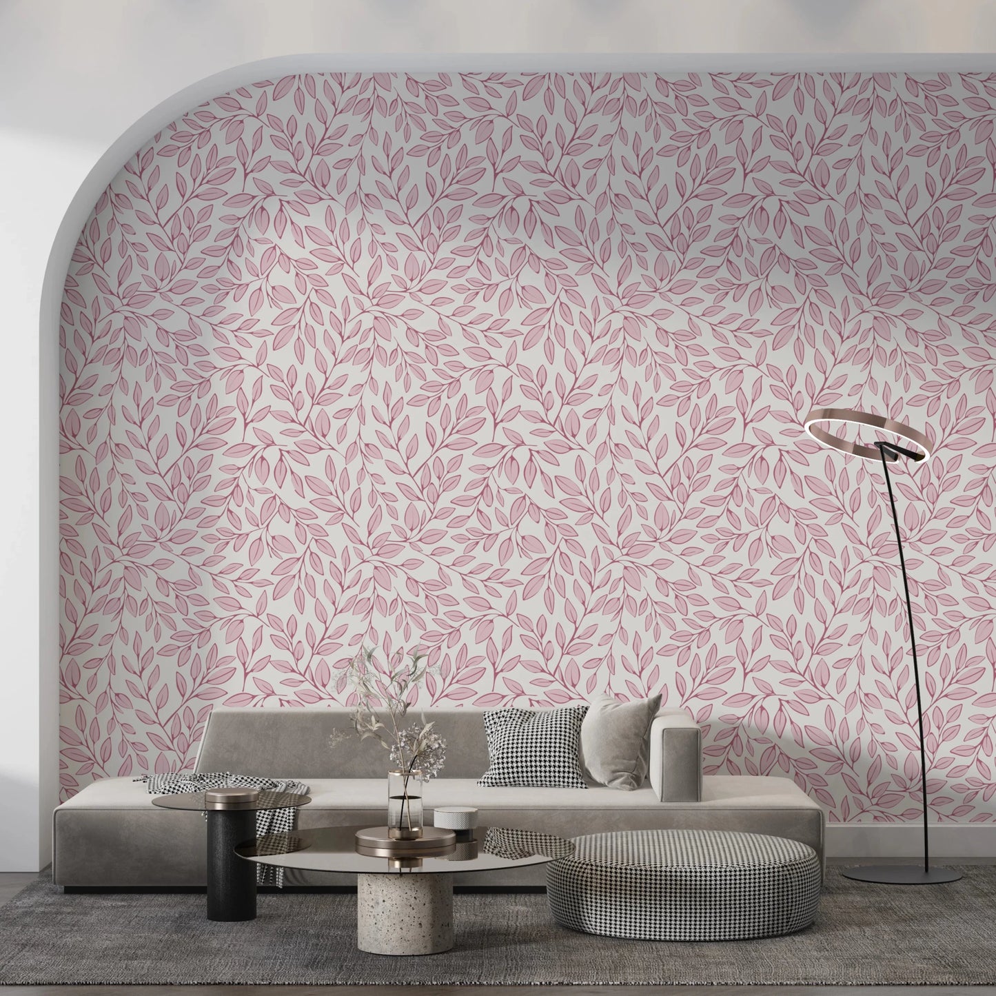 Dusty Rose Vines wallpaper with pink leaves on an arched wall behind a grey sofa and round travertine table