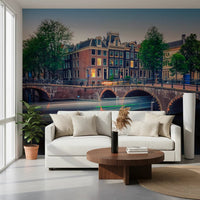 Dutch Canal Dreams wallpaper mural of the twilight canal and stone bridge behind a white sofa and round walnut table