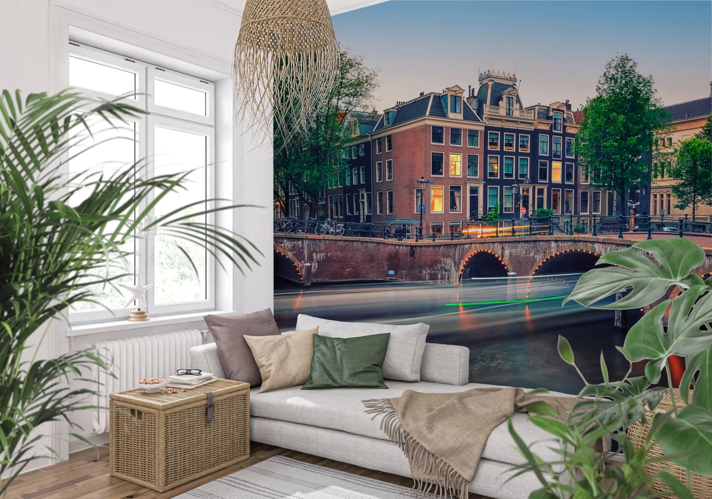 Dutch Canal Dreams wallpaper mural of Amsterdam houses and canal above a white sofa framed by green leafy plants
