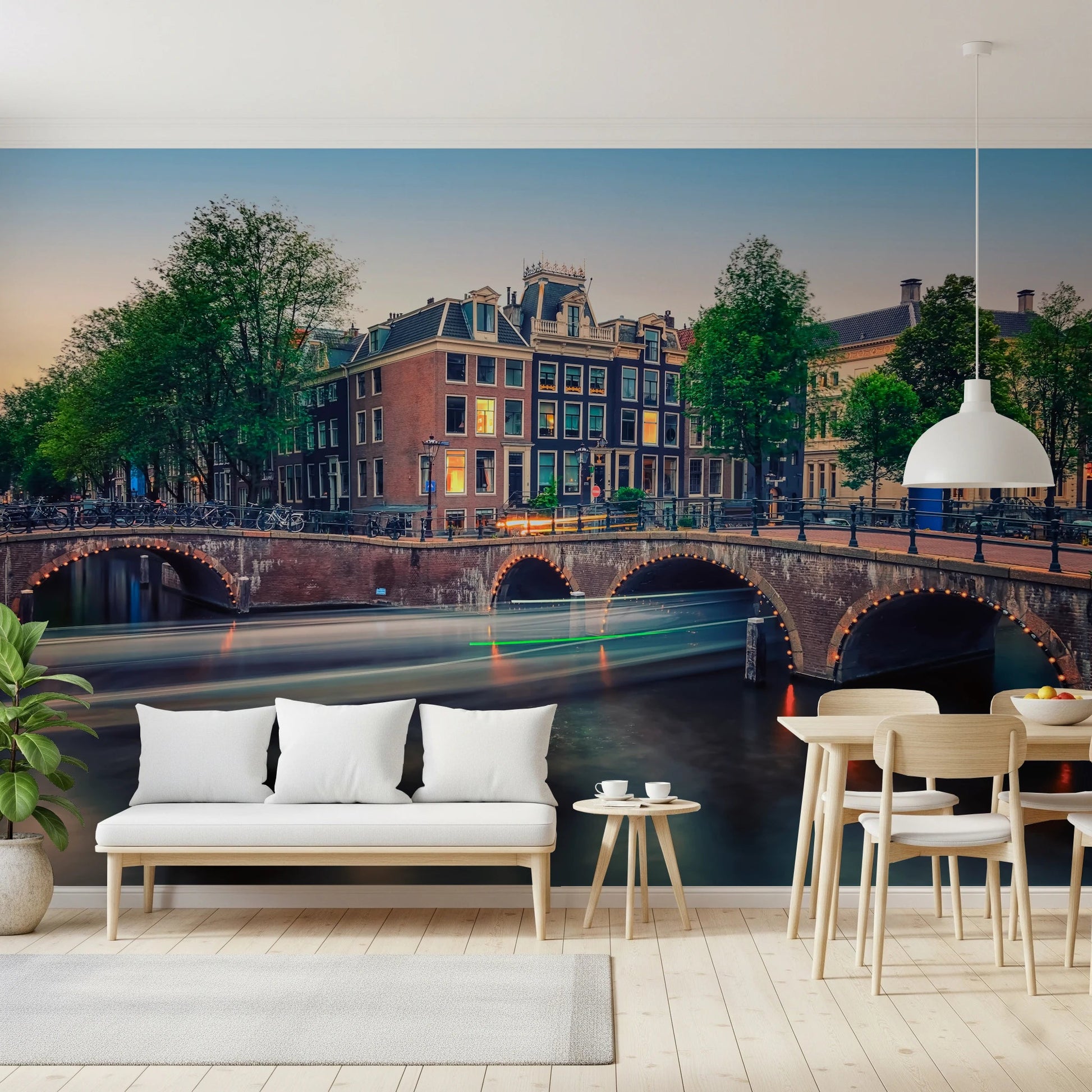 Dutch Canal Dreams wallpaper mural of Amsterdam canal houses behind a white bench and pale wood dining chairs