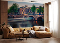 Dutch Canal Dreams wallpaper mural of the glowing canal at dusk above a tan leather sectional in a living room