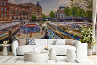 Dutch Waterways wallpaper mural of canal tour boats behind a white curved sofa and round tables in a living room