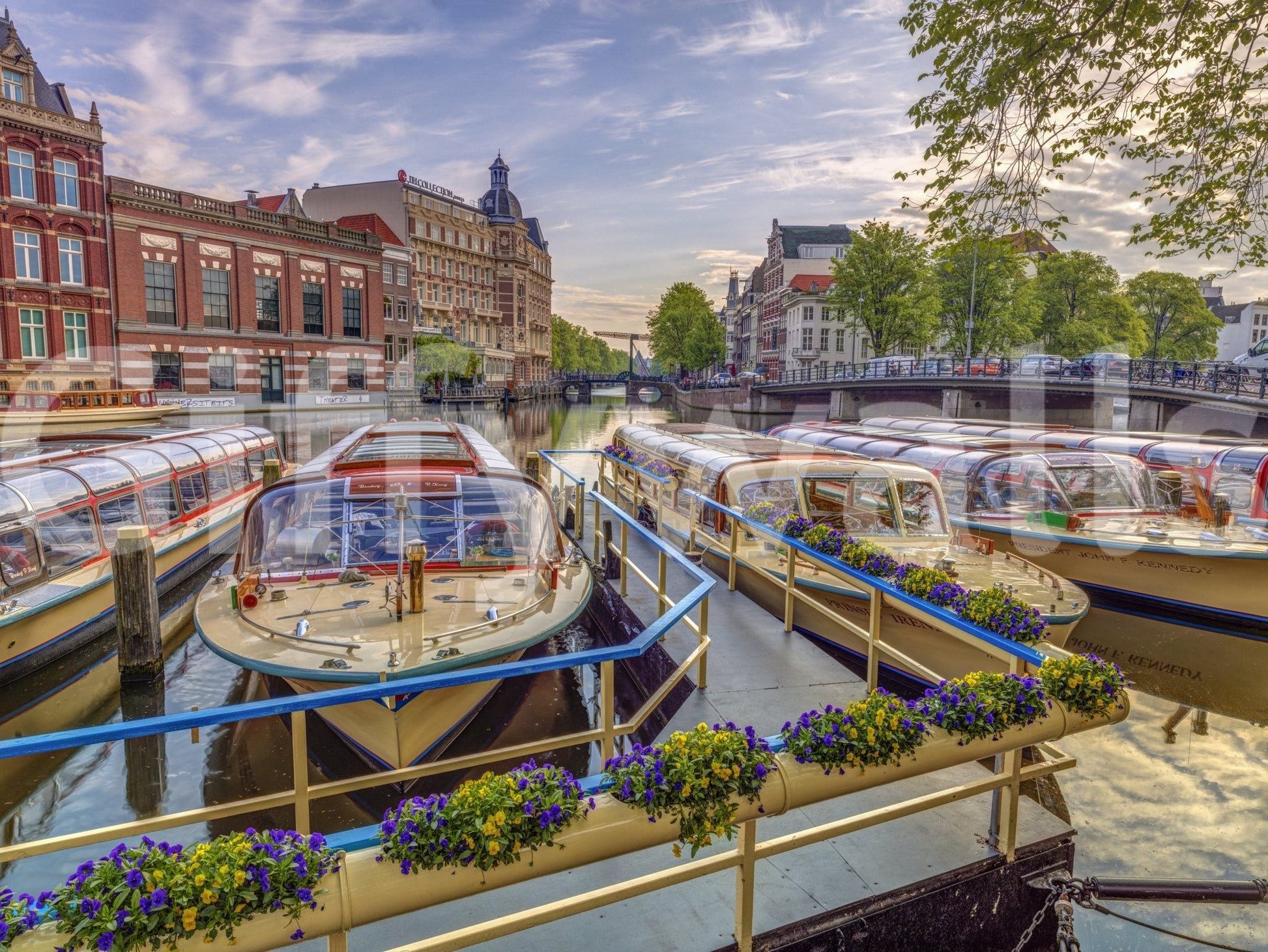 Dutch Waterways wallpaper mural shown as a full-wall view of moored canal boats with purple and yellow flower boxes