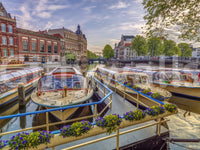 Dutch Waterways wallpaper mural shown as a full-wall view of moored canal boats with purple and yellow flower boxes