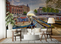 Dutch Waterways wallpaper mural of moored Amsterdam canal boats behind a gray sofa and cane armchairs in a living room