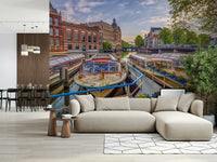 Dutch Waterways wallpaper mural of canal boats behind a beige sectional sofa by a wood-slat divider in a living room