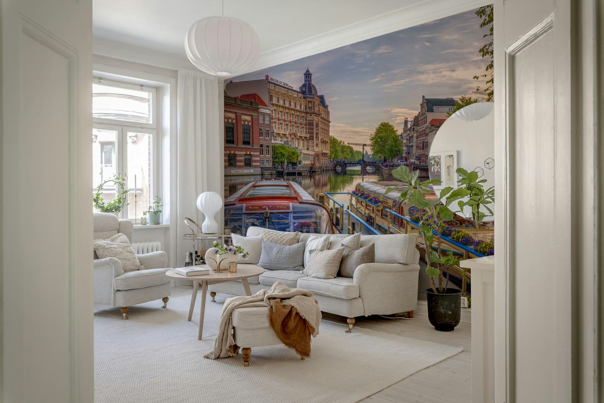 Dutch Waterways wallpaper mural of Amsterdam canal boats behind a white sofa and armchair in a living room