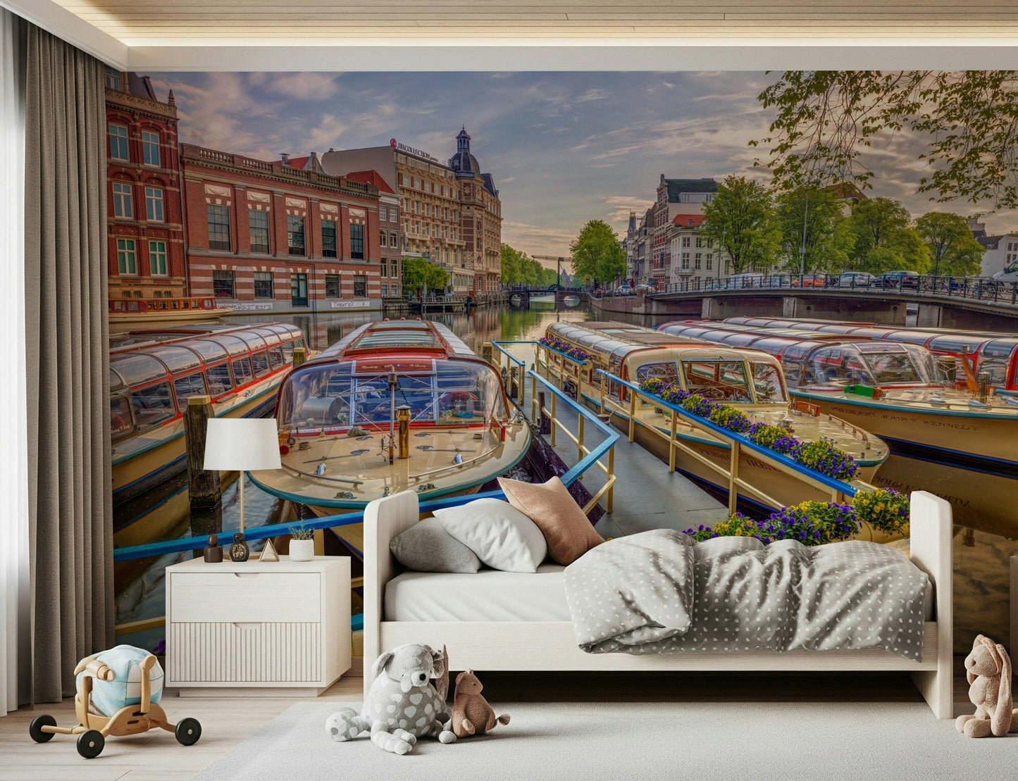 Dutch Waterways wallpaper mural of moored canal boats above a white toddler bed with toys in a kids room