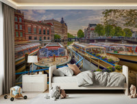 Dutch Waterways wallpaper mural of moored canal boats above a white toddler bed with toys in a kids room