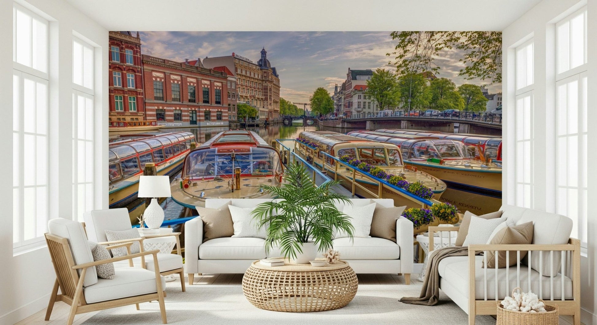 Dutch Waterways wallpaper mural of Amsterdam canal boats behind two white sofas and a palm in a bright living room