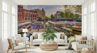 Dutch Waterways wallpaper mural of Amsterdam canal boats behind two white sofas and a palm in a bright living room