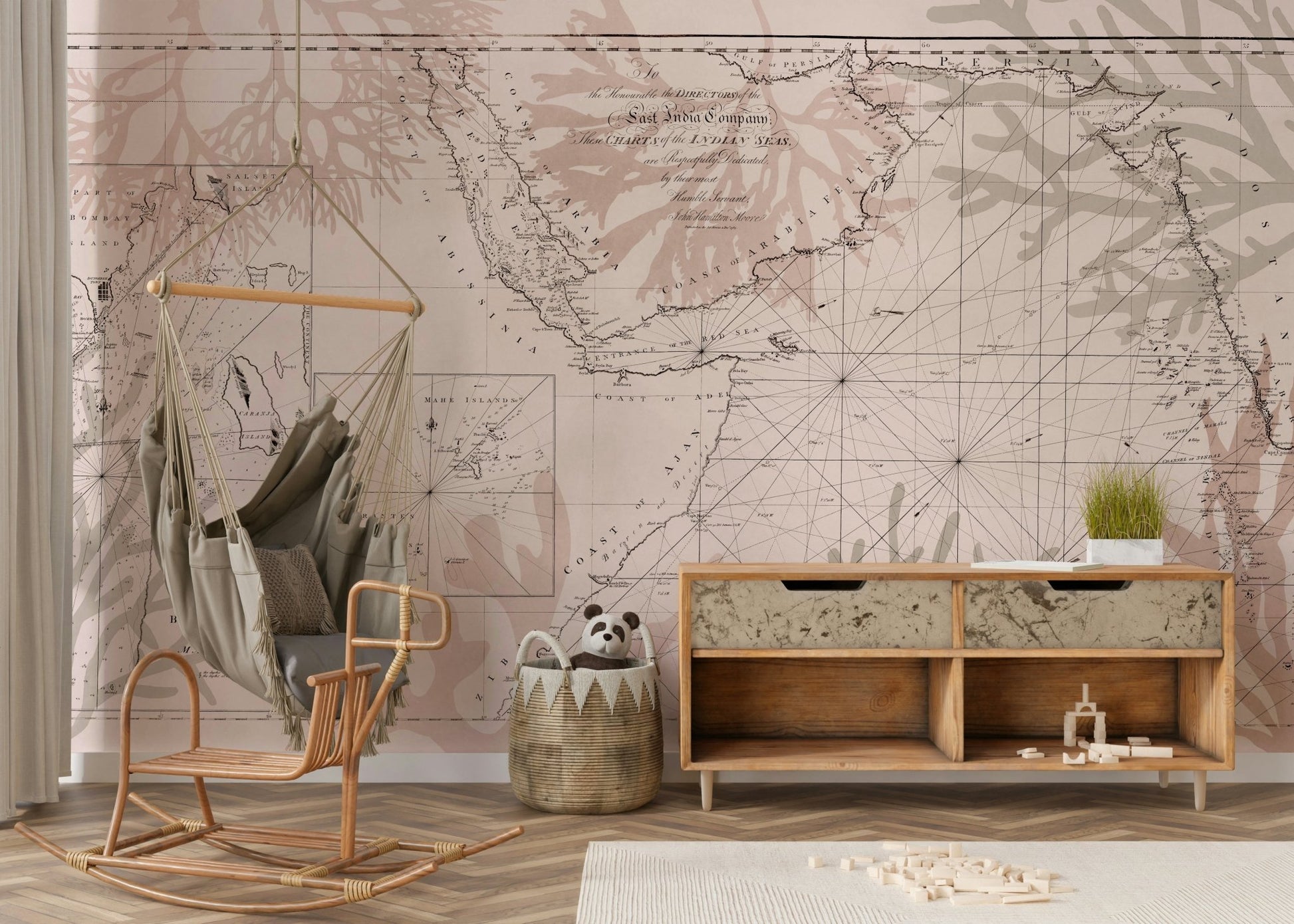 Wall mural with old-world map and greenery

