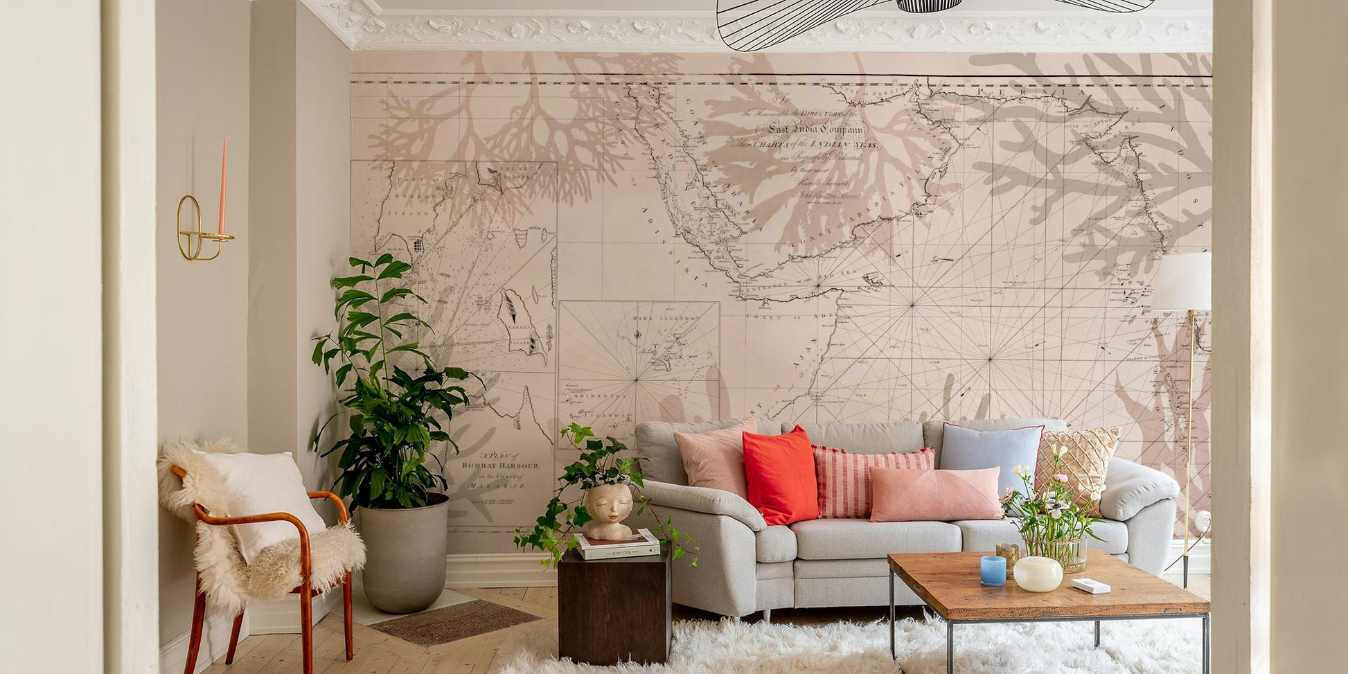 Coastal adventure mural with compass and foliage
